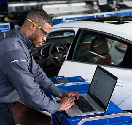 image of a mechanic looking at a laptop